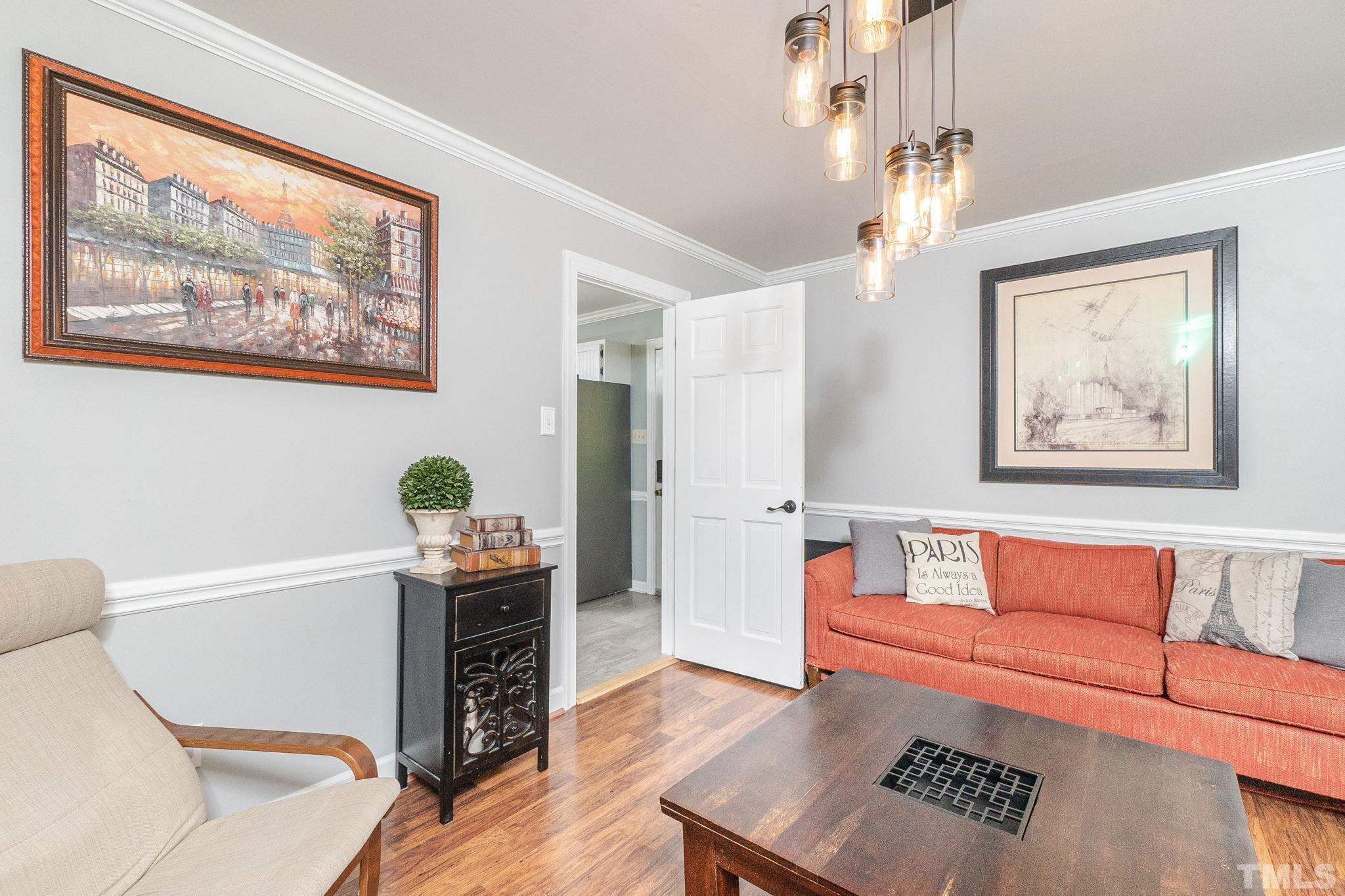 6313 Craig Road Durham, NC 27712 - Photo 10 of 38 a living room with furniture and a flat screen tv