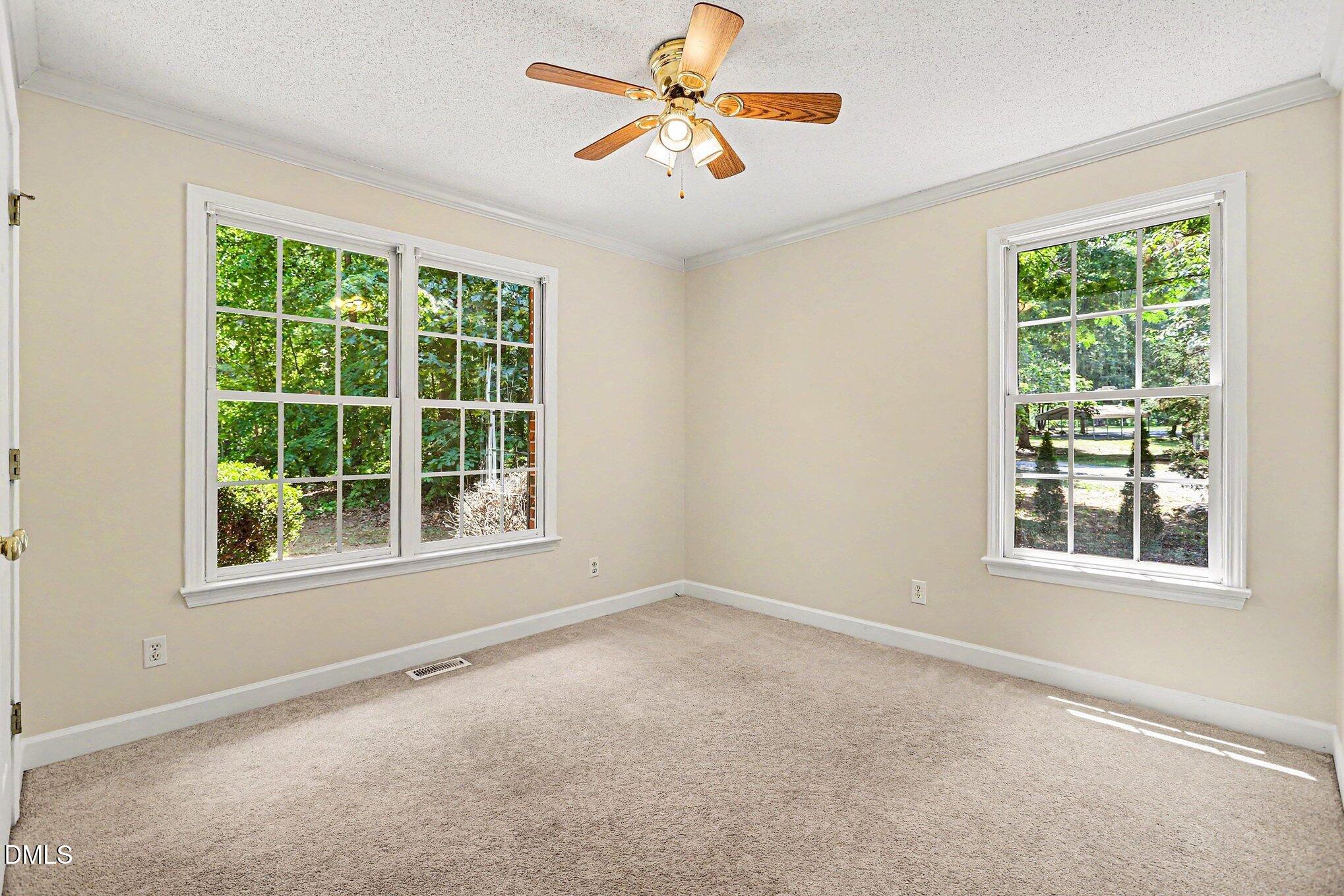 5359 Bass Mountain Road Snow Camp, NC 27349 - Photo 11 of 25 an empty room with a window and a fan