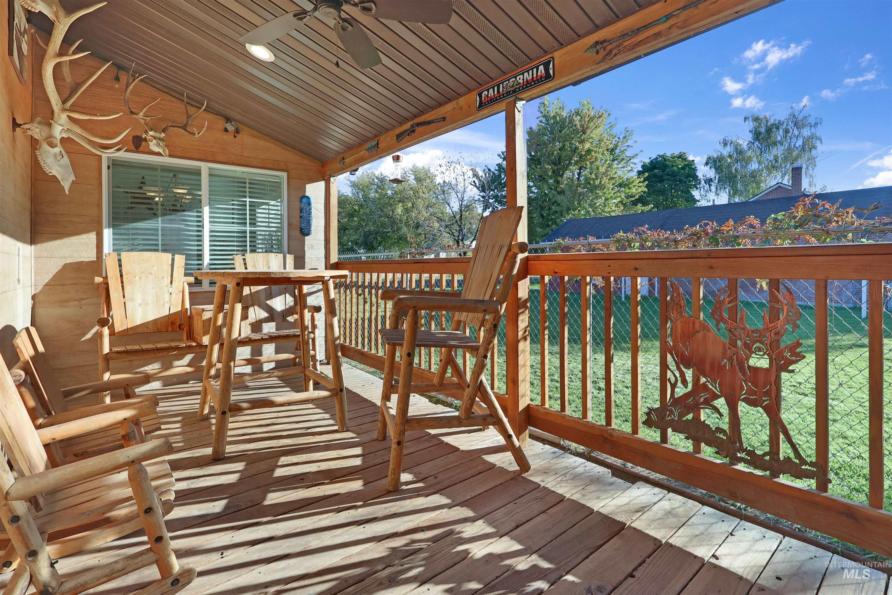 1009 9th Street Rupert, ID 83350 - Photo 17 of 28 Covered wood-finish porch featuring a ceiling fan with integrated lighting, wood-finish flooring, and a sliding glass door
