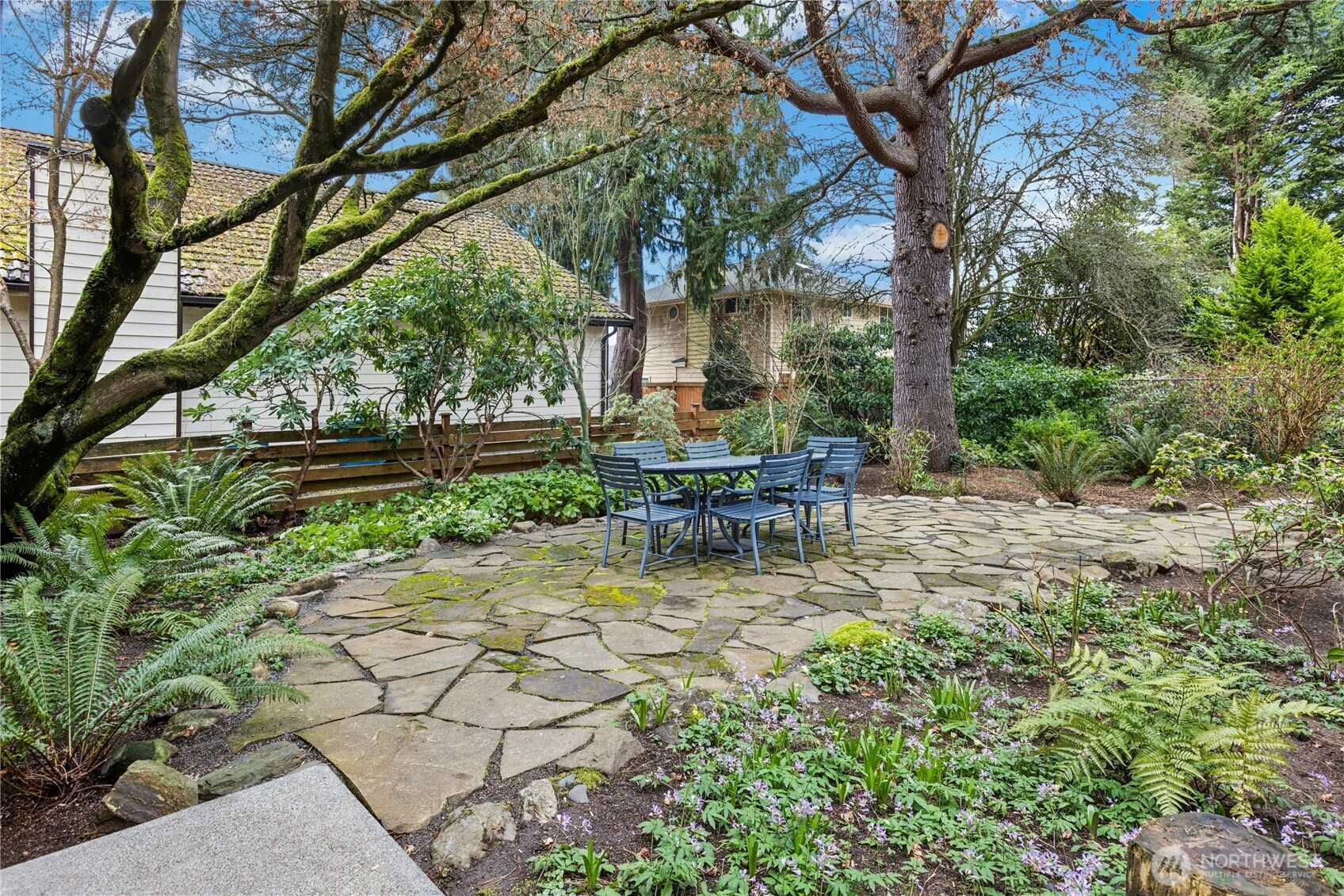 21214 96th Avenue West Edmonds, WA 98020 - Photo 11 of 40 a view of backyard with a table and chairs and a large tree