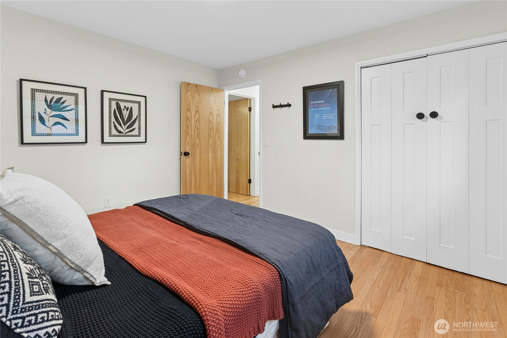 21214 96th Avenue West Edmonds, WA 98020 - Photo 27 of 40 a bedroom with a bed and painting on the wall