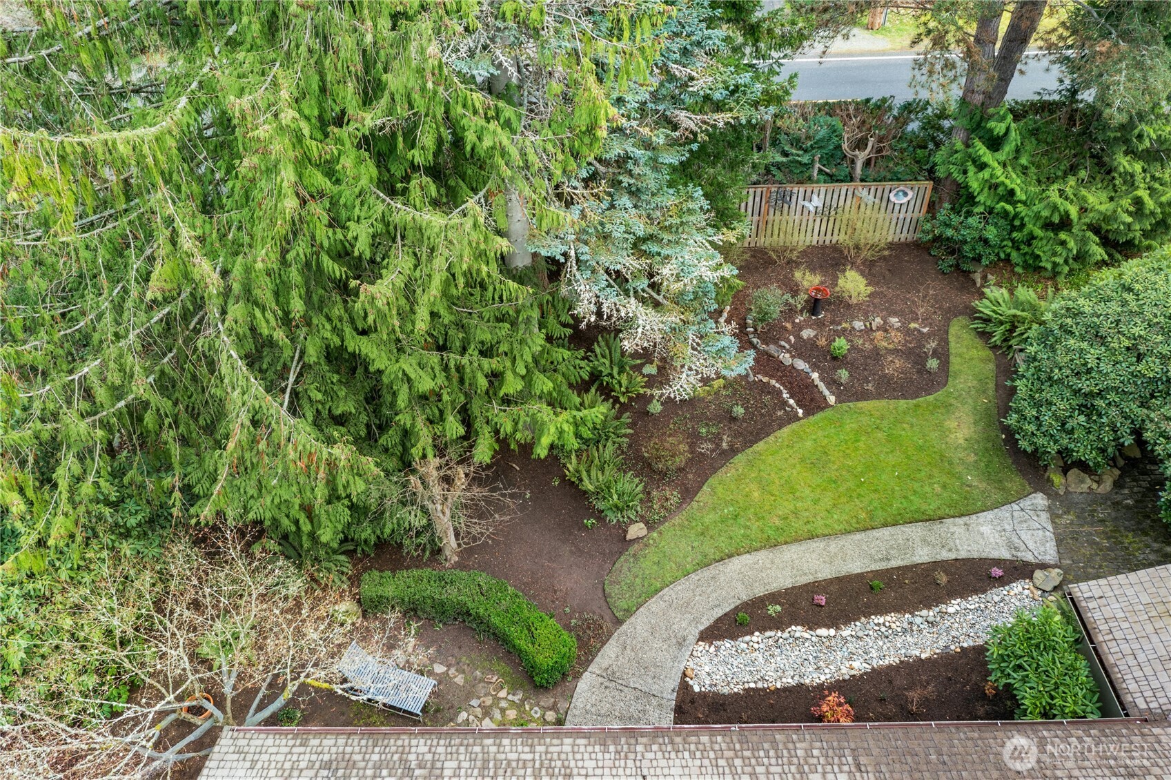 21214 96th Avenue West Edmonds, WA 98020 - Photo 35 of 40 a view of a garden with a bench
