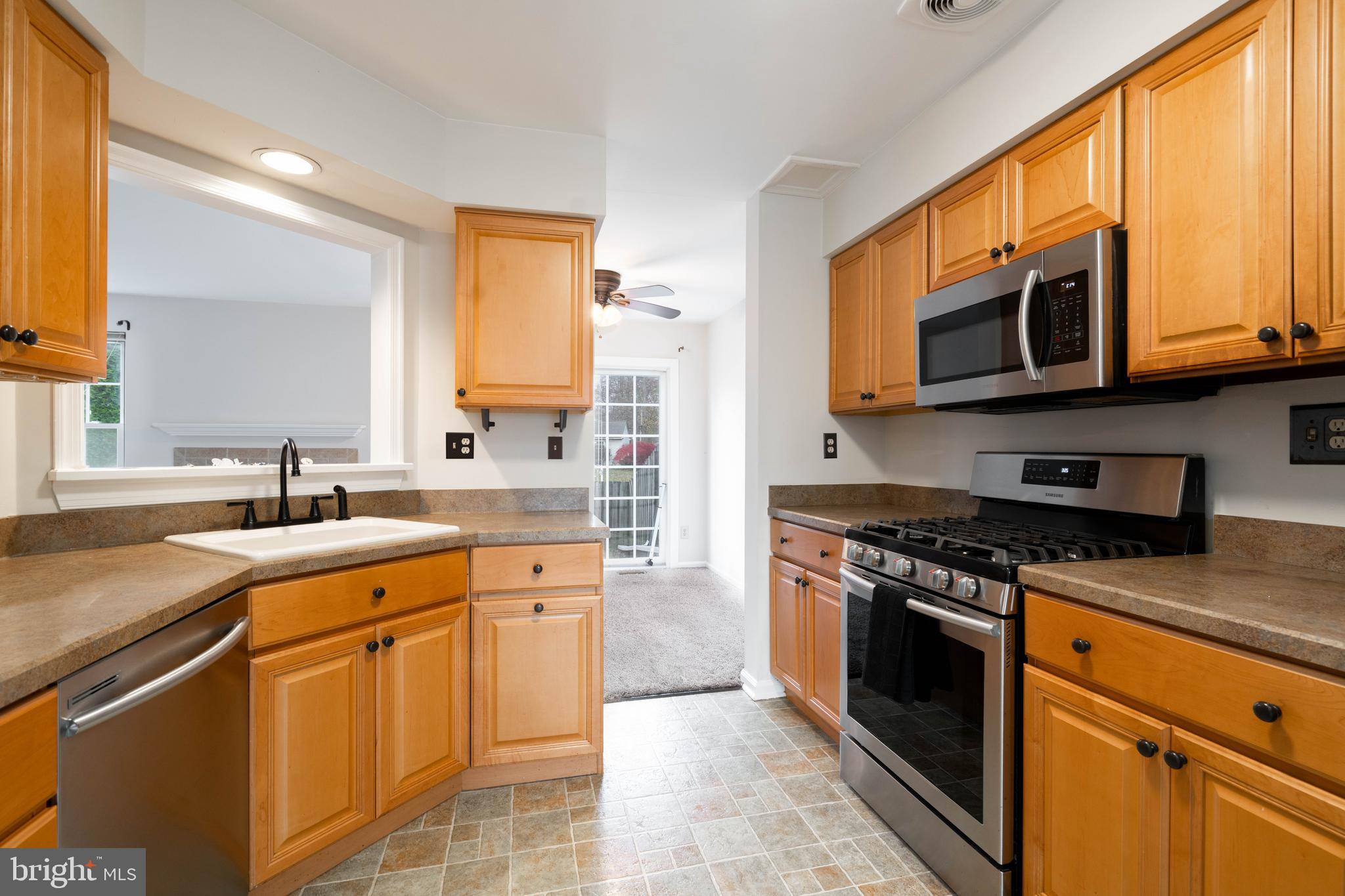 2420 Dogleg Drive Warrington, PA 18976 - Photo 4 of 28 a kitchen with stainless steel appliances granite countertop a stove sink microwave and cabinets