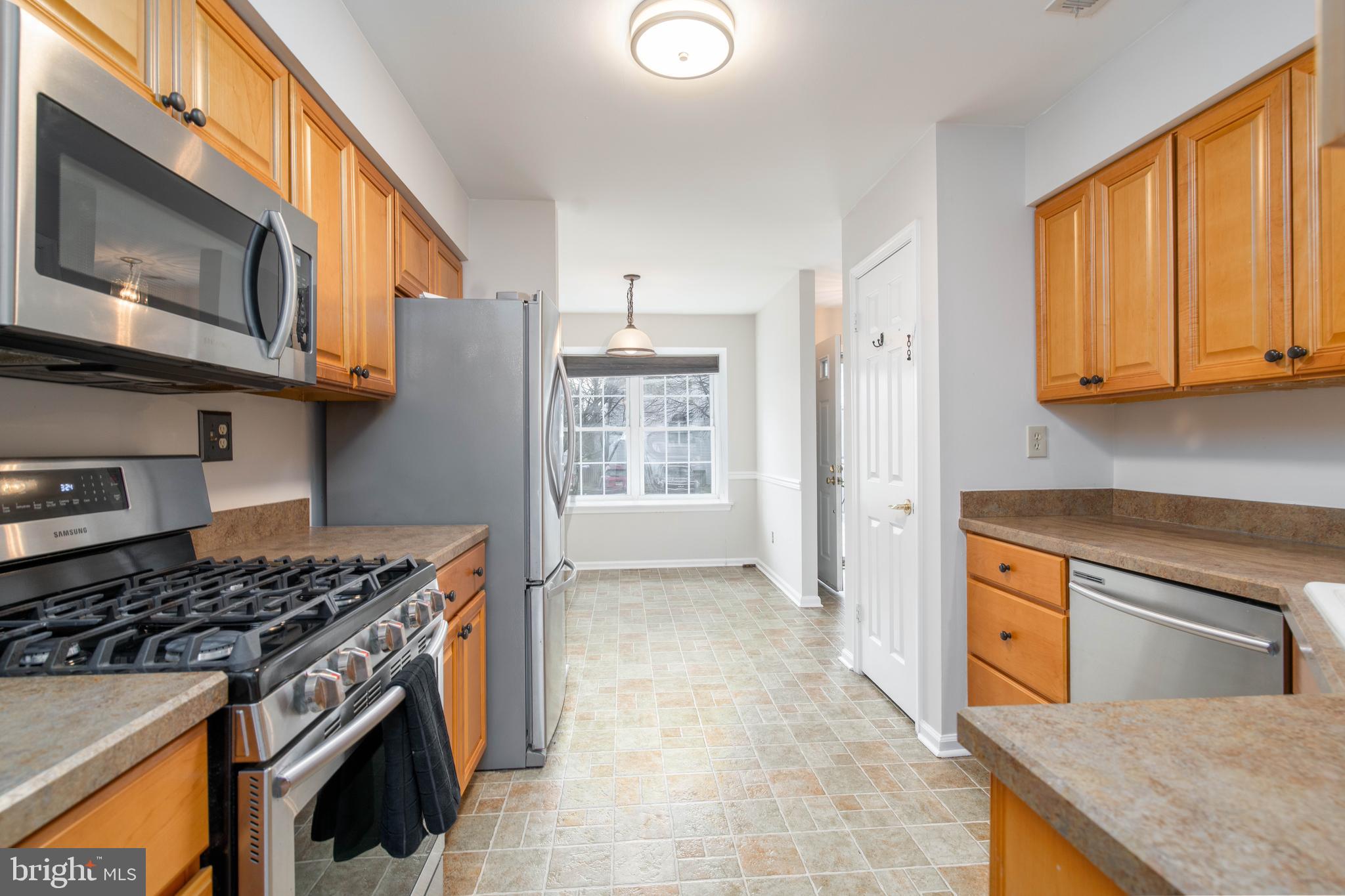 2420 Dogleg Drive Warrington, PA 18976 - Photo 5 of 28 a kitchen with stainless steel appliances granite countertop a stove a sink and a microwave
