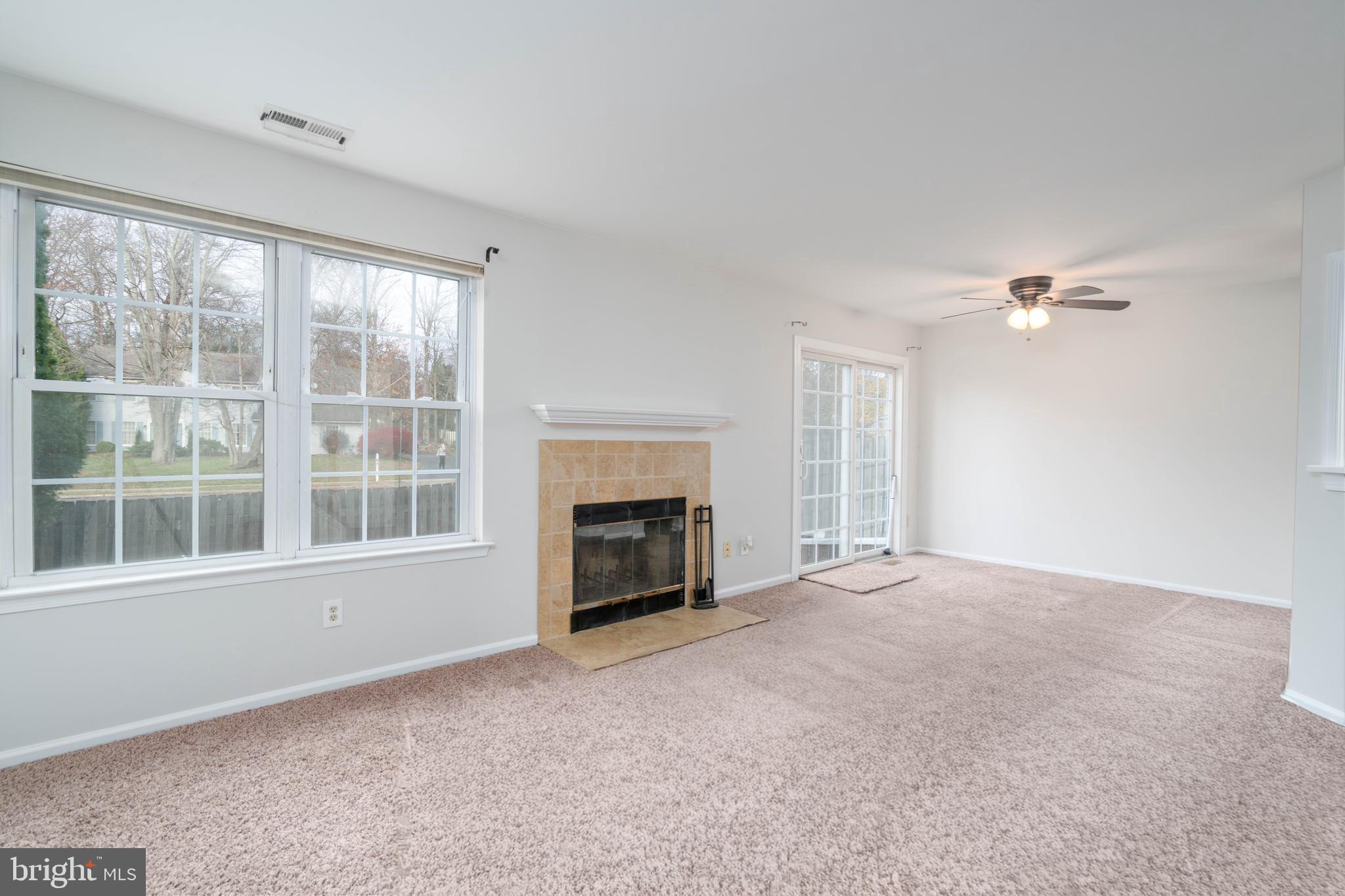 2420 Dogleg Drive Warrington, PA 18976 - Photo 7 of 28 a view of an empty room with a window and a fireplace