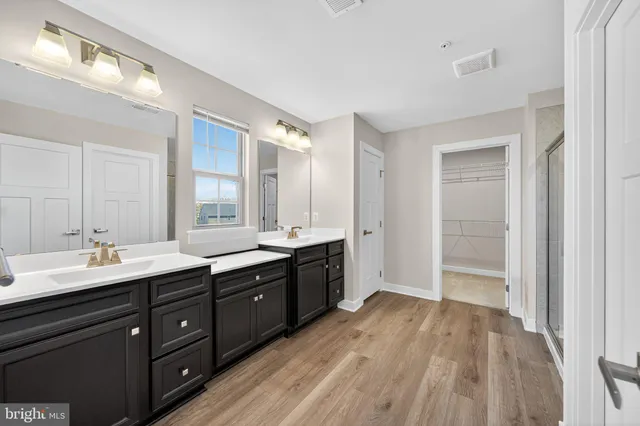 a spacious bathroom with a double vanity sink and mirror