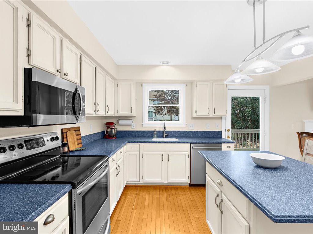 1560 Ritchie Lane Annapolis, MD 21401 - Photo 11 of 54 a kitchen with stainless steel appliances a sink a stove a microwave and cabinets