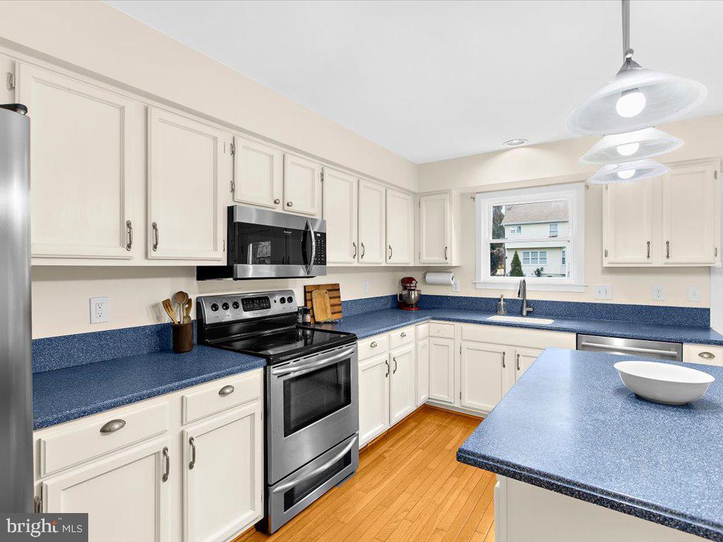 1560 Ritchie Lane Annapolis, MD 21401 - Photo 12 of 54 a kitchen with granite countertop a sink stainless steel appliances and white cabinets