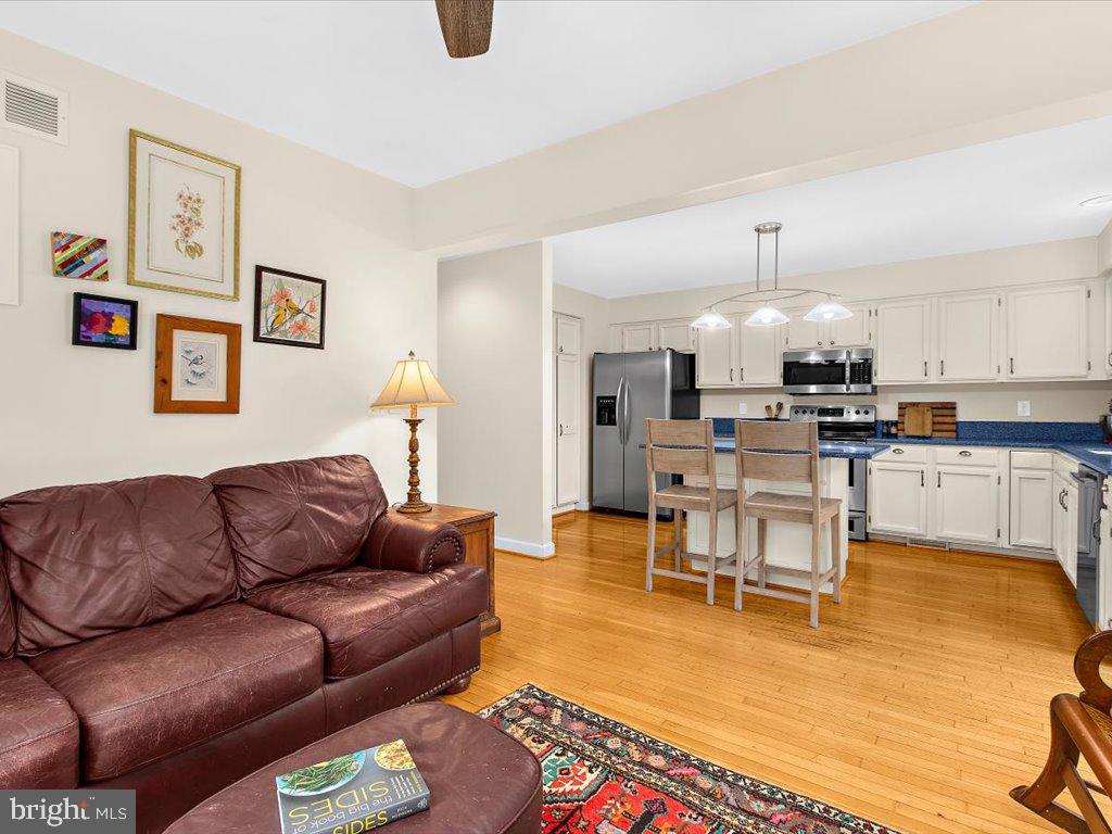 1560 Ritchie Lane Annapolis, MD 21401 - Photo 13 of 54 a living room with furniture kitchen view and a wooden floor