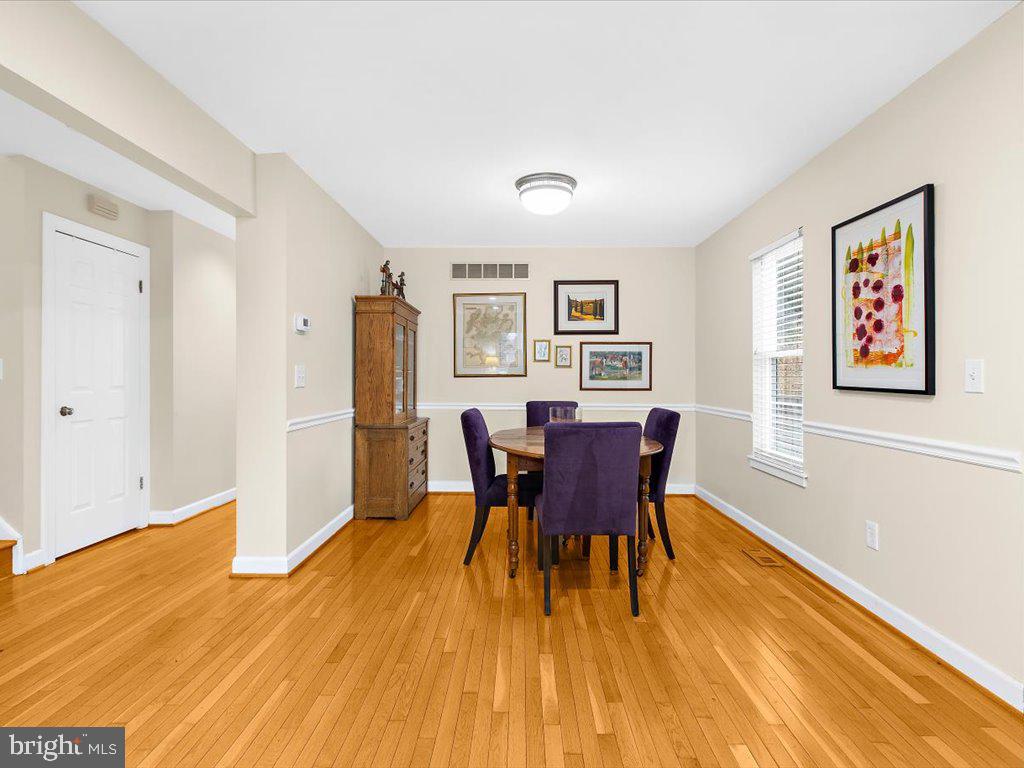 1560 Ritchie Lane Annapolis, MD 21401 - Photo 18 of 54 a view of a dining room with furniture and wooden floor