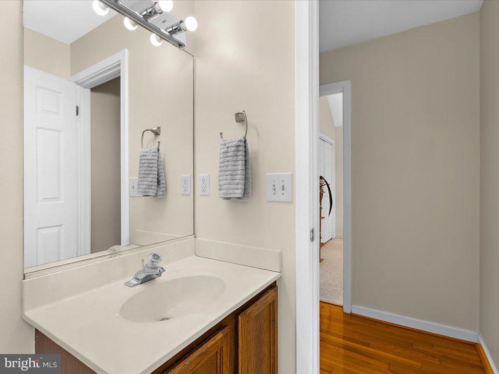 1560 Ritchie Lane Annapolis, MD 21401 - Photo 27 of 54 a bathroom with a sink vanity and a mirror