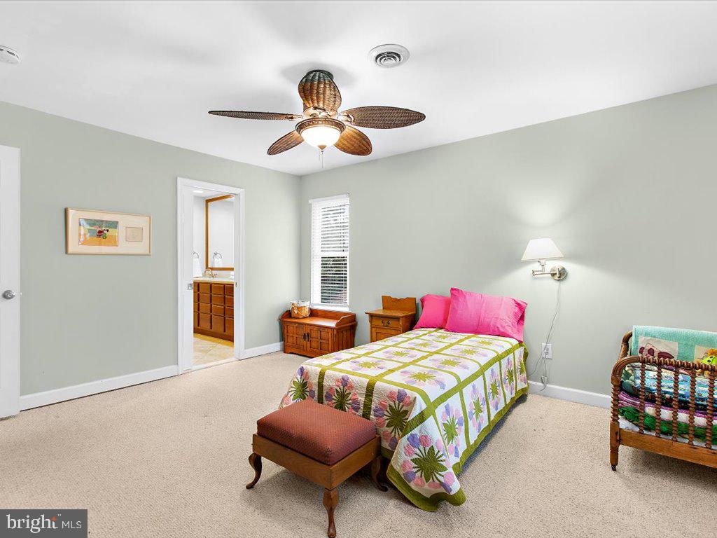 1560 Ritchie Lane Annapolis, MD 21401 - Photo 29 of 54 a bedroom with two beds and painting on the wall