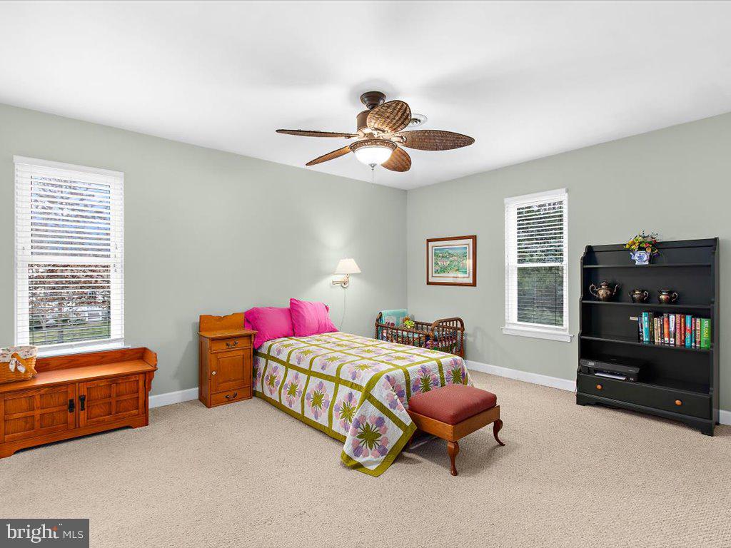 1560 Ritchie Lane Annapolis, MD 21401 - Photo 30 of 54 a bedroom with a bed and a chandelier