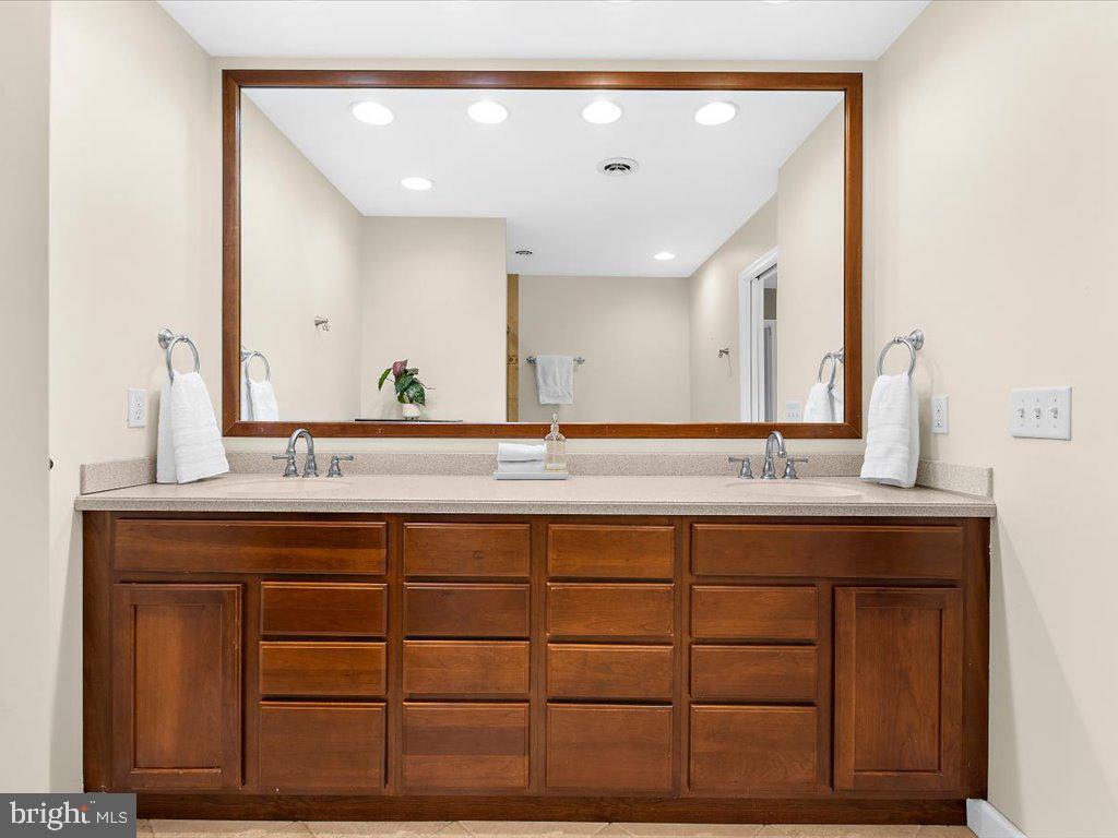 1560 Ritchie Lane Annapolis, MD 21401 - Photo 33 of 54 a bathroom with a double vanity sink and a mirror