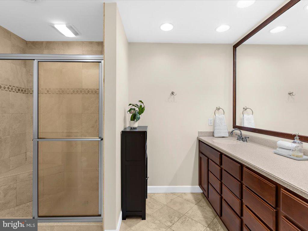1560 Ritchie Lane Annapolis, MD 21401 - Photo 34 of 54 a bathroom with a double vanity sink and a mirror