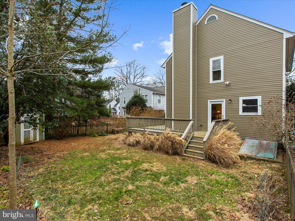 1560 Ritchie Lane Annapolis, MD 21401 - Photo 45 of 54 a backyard of a house with large trees and wooden fence