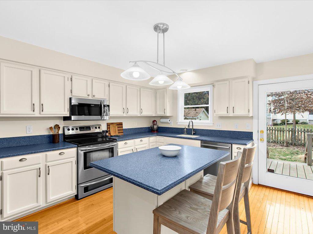 1560 Ritchie Lane Annapolis, MD 21401 - Photo 5 of 54 a kitchen with a table chairs stove microwave and cabinets