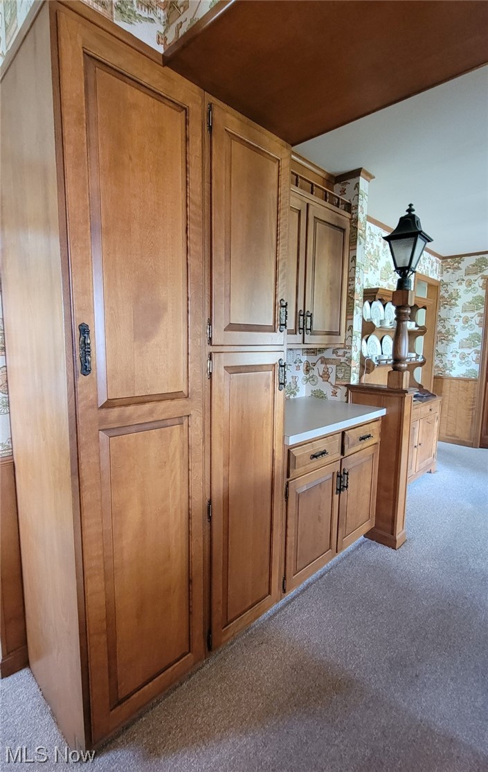 6416 Milan Road Sandusky, OH 44870 - Photo 14 of 34 Kitchen with light carpet and brown cabinets