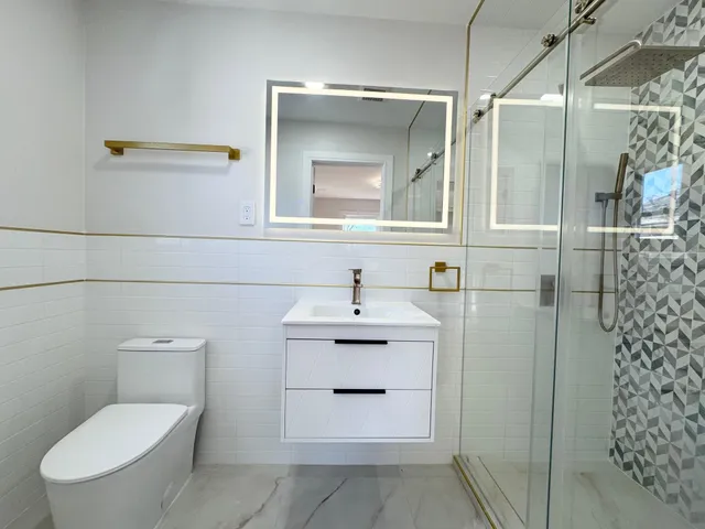 a bathroom with a sink a mirror and a shower