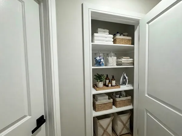 a large kitchen with a refrigerator and a stove top oven