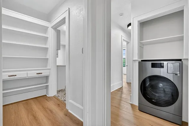 a view of a hallway with washer and dryer