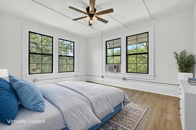 a spacious bedroom with a large bed and a large window