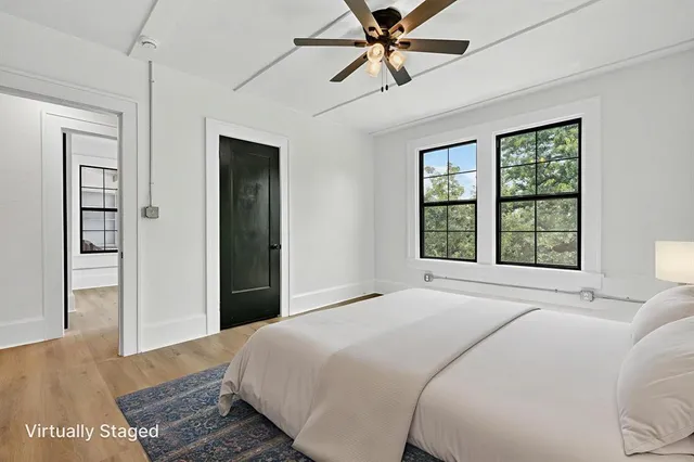 a bedroom with a large bed and a window