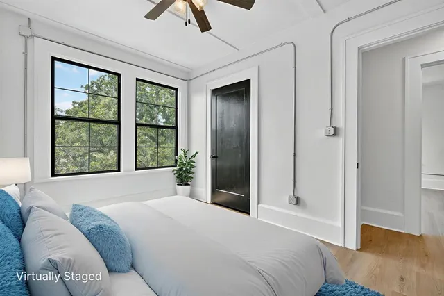 a bedroom with a bed and a painting on the wall