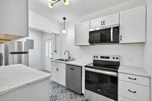 a kitchen with a stove and a microwave