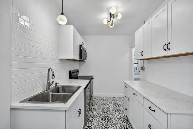 a kitchen with sink cabinets and window