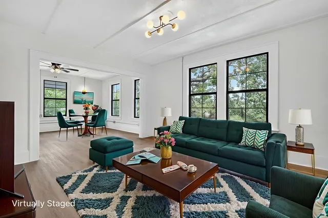 a living room with furniture and wooden floor