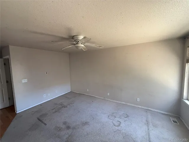 an empty room with a fan