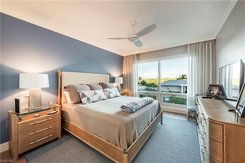 13915 Old Coast Road, Unit 302 Naples, FL 34110 - Photo 12 of 40 a bedroom with a bed and a large window