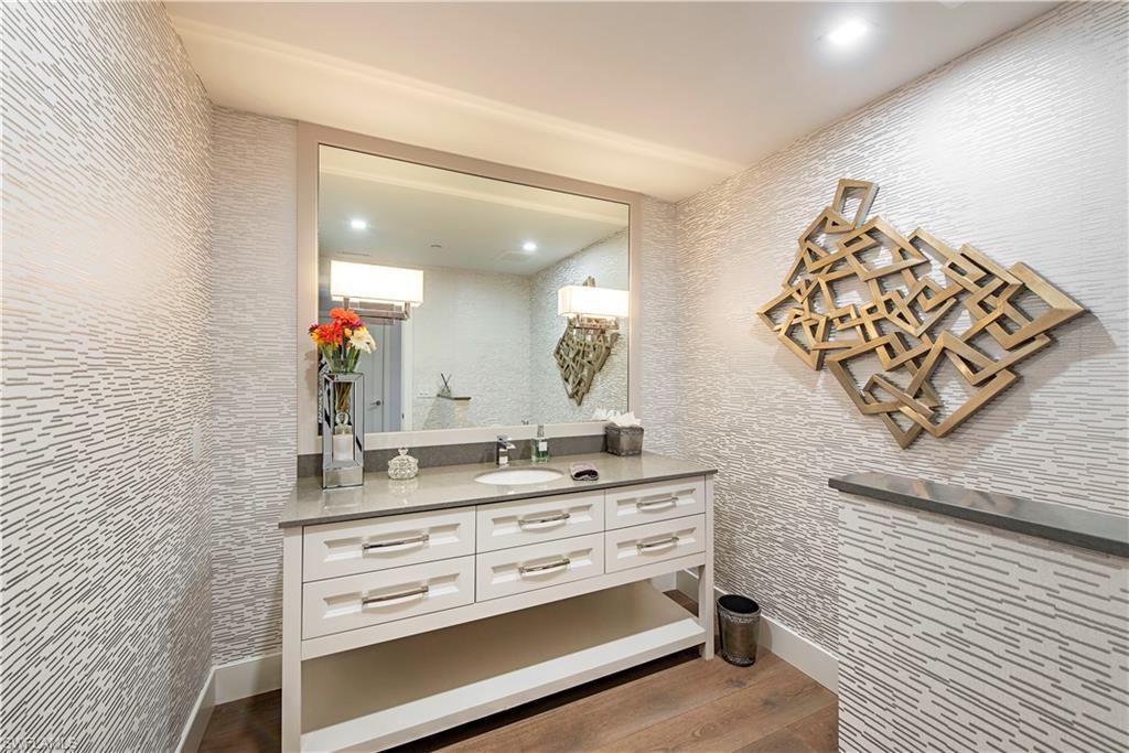 13915 Old Coast Road, Unit 302 Naples, FL 34110 - Photo 15 of 40 a bathroom with a sink and a mirror