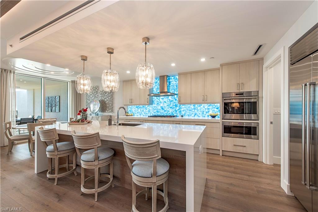 13915 Old Coast Road, Unit 302 Naples, FL 34110 - Photo 4 of 40 a kitchen with a table and chairs in it
