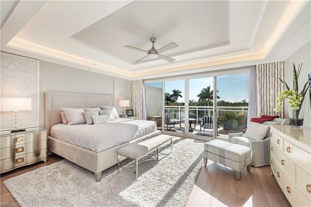 13915 Old Coast Road, Unit 302 Naples, FL 34110 - Photo 7 of 40 a spacious bedroom with a bed a couch and a window