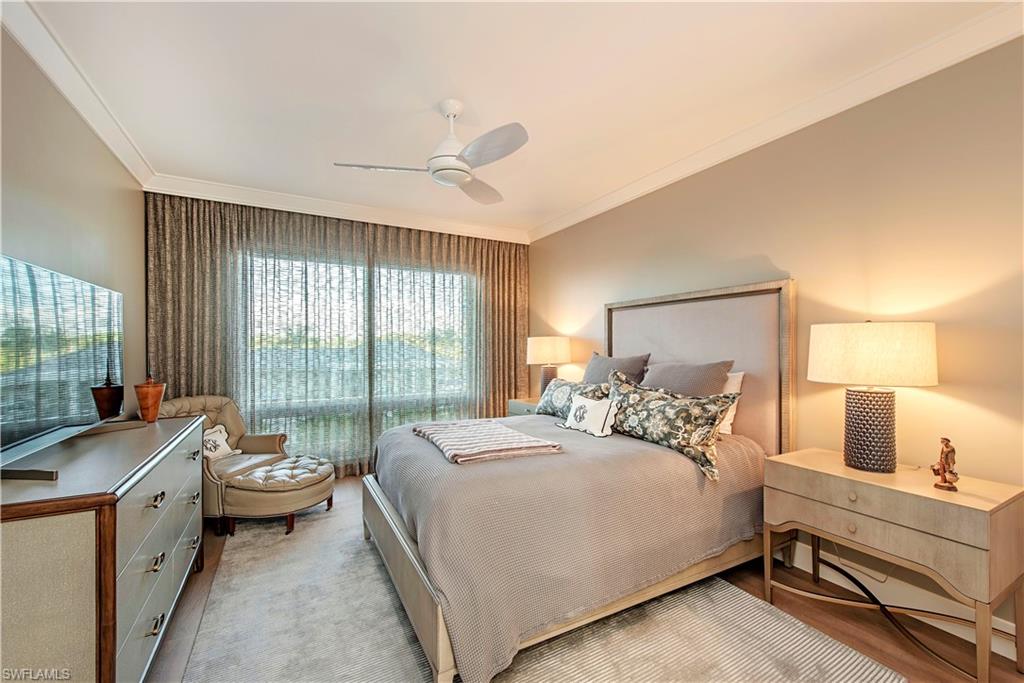 13915 Old Coast Road, Unit 302 Naples, FL 34110 - Photo 10 of 40 a bedroom with a bed and large windows
