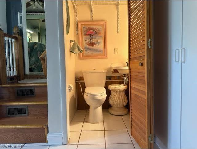 186 Panther Pass Circle, Unit 186 Naples, FL 34114 - Photo 35 of 50 a bathroom with a toilet and a mirror