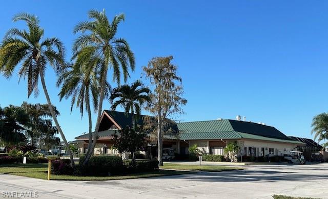 186 Panther Pass Circle, Unit 186 Naples, FL 34114 - Photo 40 of 50 a front view of multiple houses with tree s