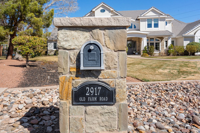 2917 Old Farm Road Washington, UT 84780 - Photo 86 of 105 View of front of house featuring stone siding, a front lawn, and covered porch
