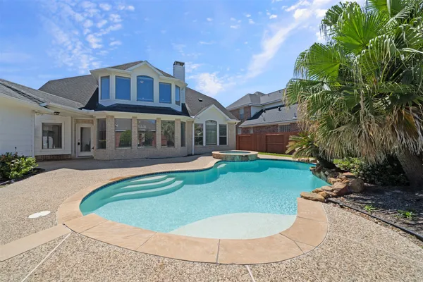 a view of a white house with a swimming pool