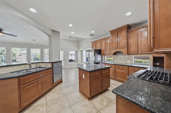 a kitchen with granite countertop stainless steel appliances lots of counter top space