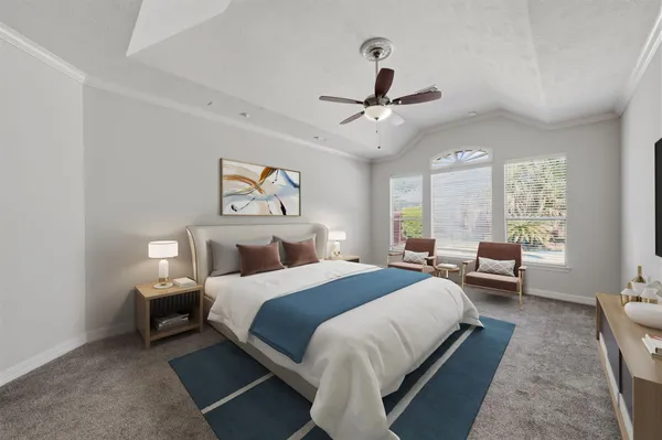 a bedroom with a bed couch and a window