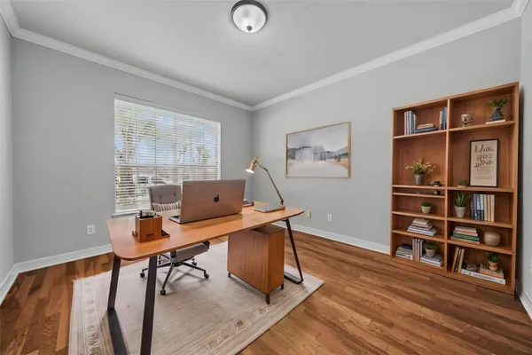 a workspace with furniture window and wooden floor