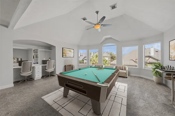 a living room with furniture a chandelier and a pool table