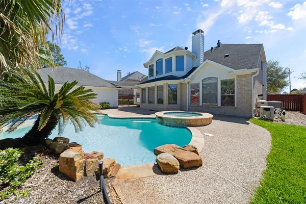 a front view of a house with swimming pool having outdoor seating