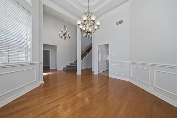 a view of livingroom with chandelier and wooden floor
