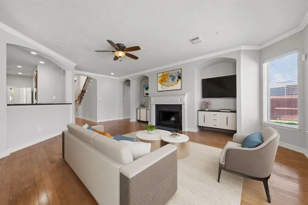 a living room with furniture a fireplace and a flat screen tv