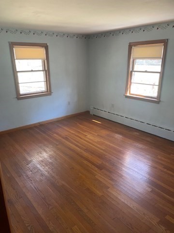 52 Peach Hill Road Berlin, MA 01503 - Photo 19 of 27 an empty room with wooden floor and windows