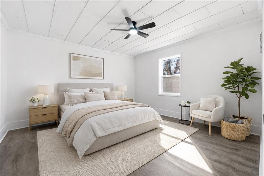 34 Wade Street Winder, GA 30680 - Photo 11 of 22 a bedroom with a bed and a potted plant